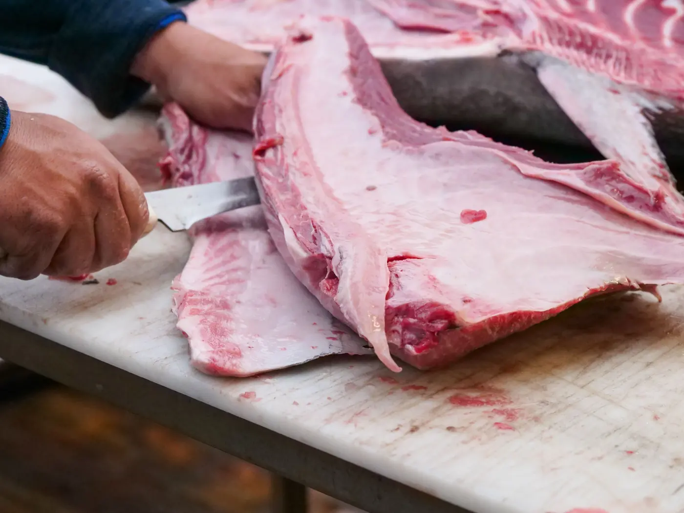 A large tuna being broken down