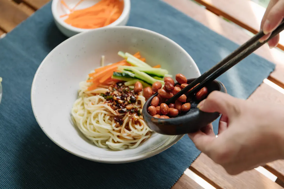 Cold noodles being dressed at the table