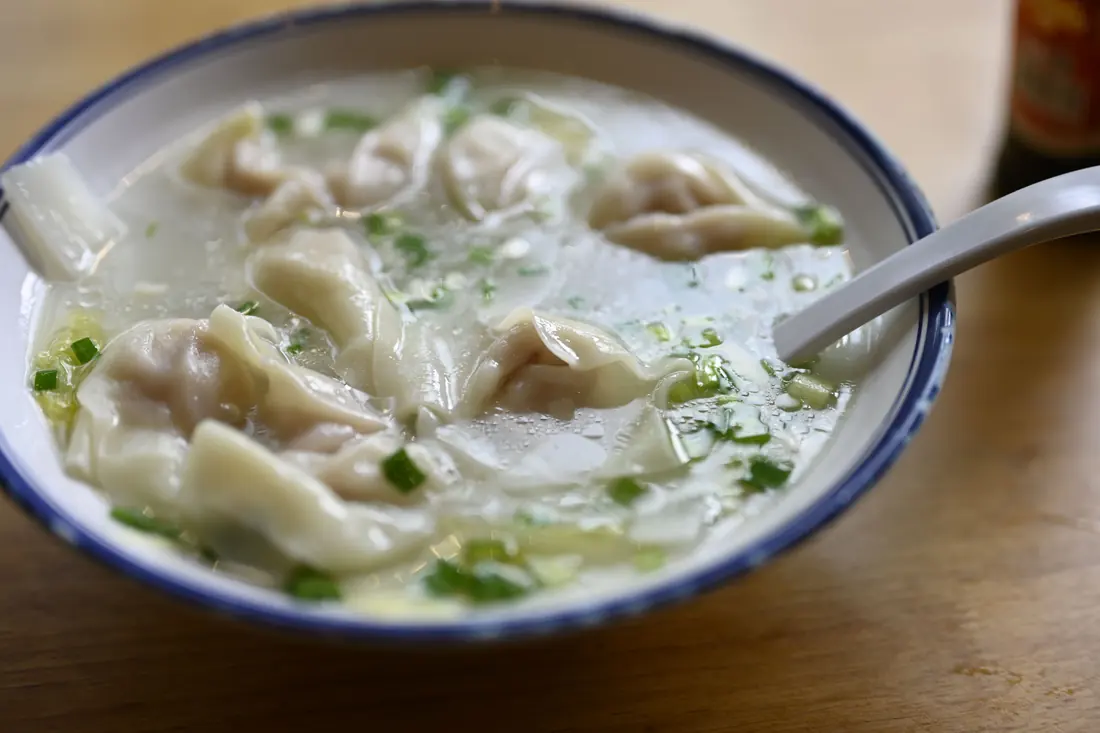 A bowl of dumplings in broth