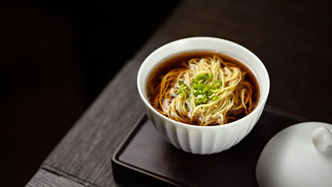 Noodles in a dark broth