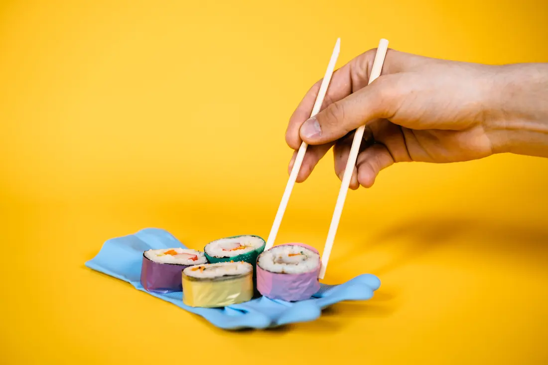 Chopsticks lifting a roll piece