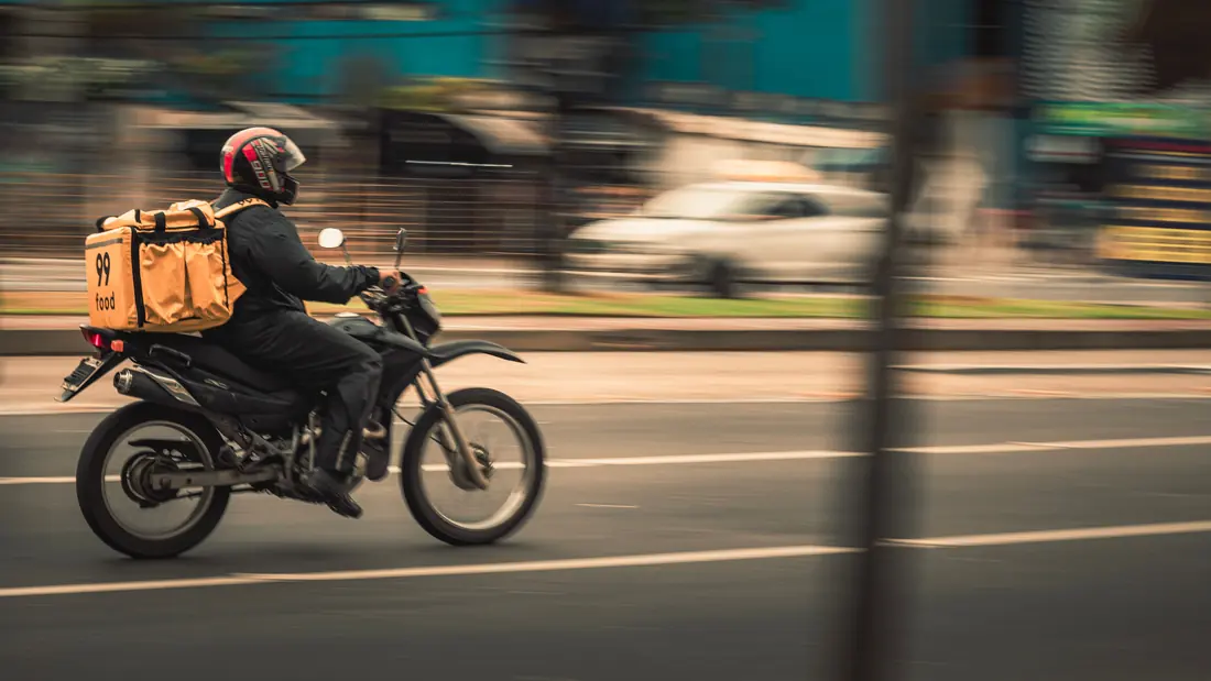 A delivery rider with a food bag