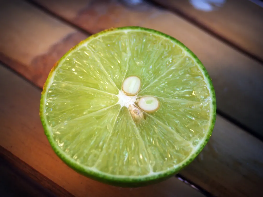 A halved citrus fruit showing pips