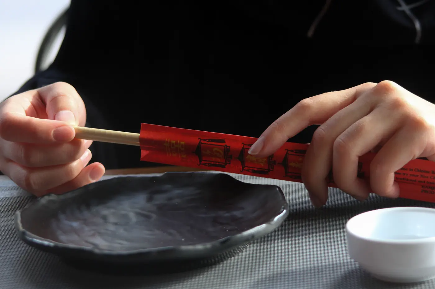 A hand holding chopsticks