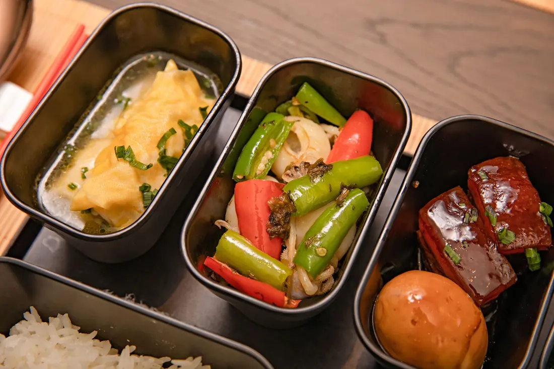 A compartmented lunch box with egg and rice