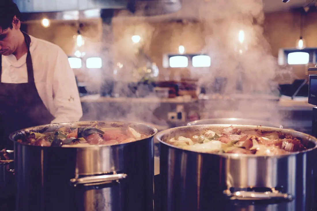 Large pots simmering in a kitchen