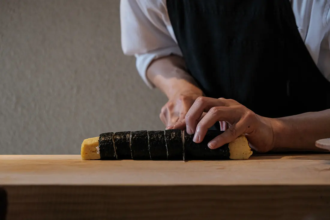 A roll being cut with a long knife