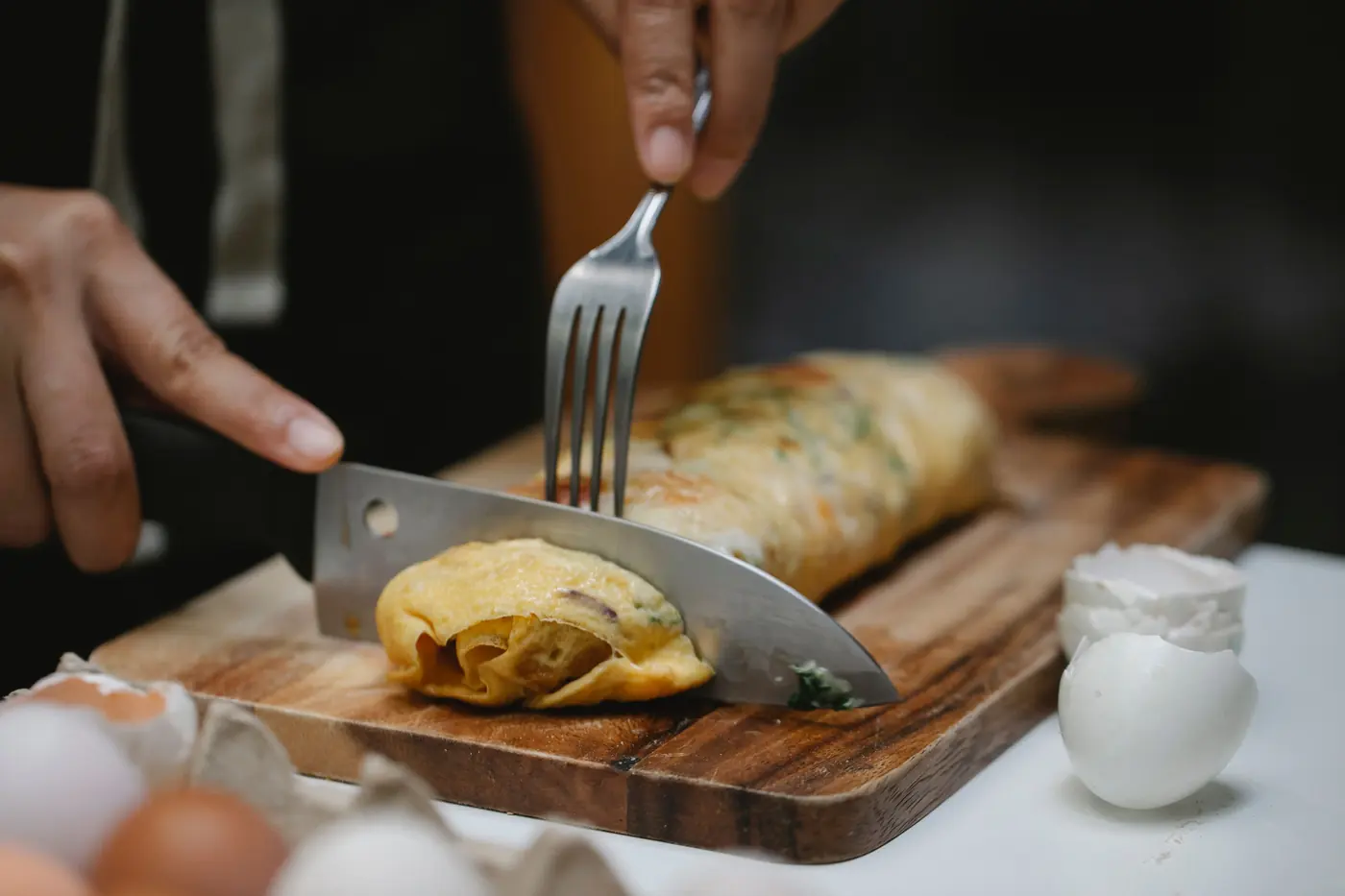 A rolled omelette being sliced