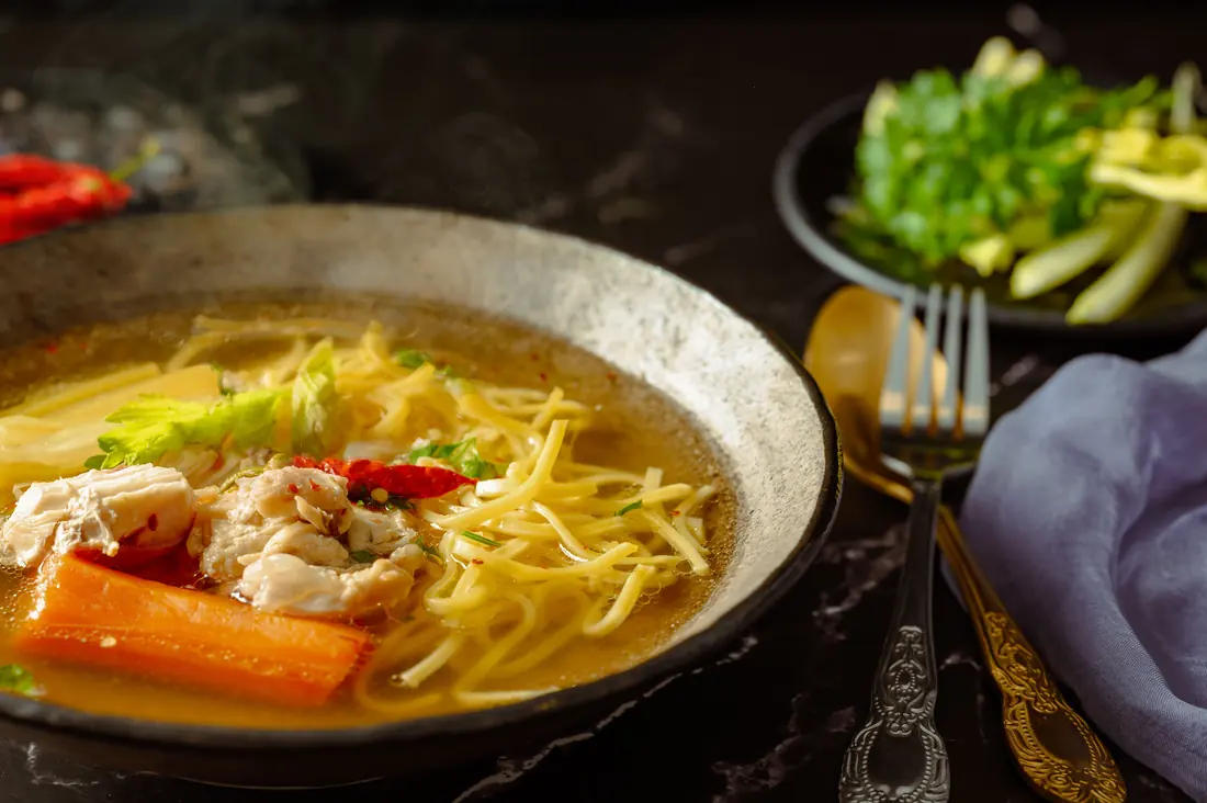 A noodle soup with vegetables