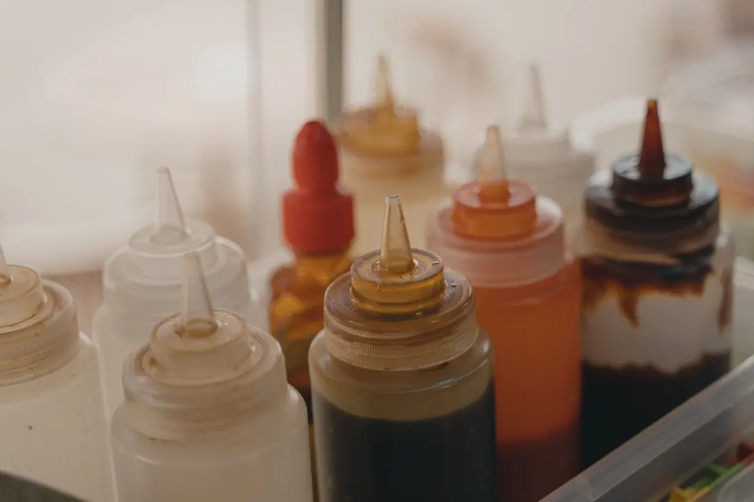 Squeeze bottles of sauces in a kitchen