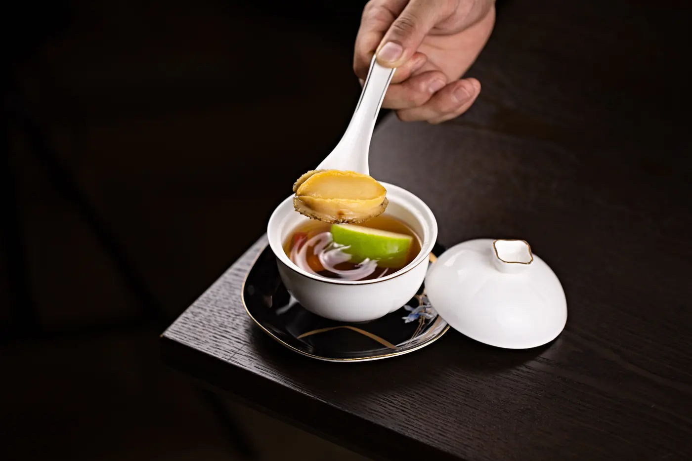 A white ceramic soup spoon