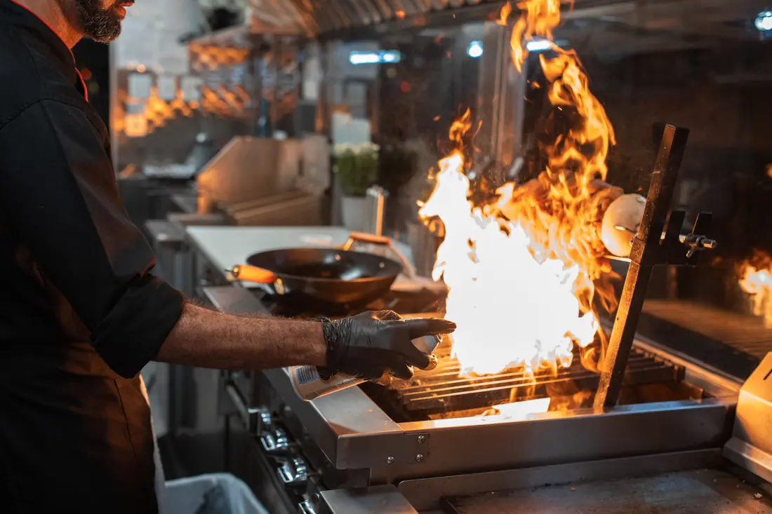 A wok being worked over a flame