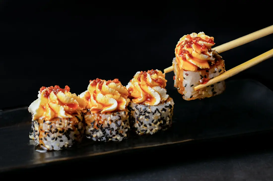 A baked sushi roll with a lightly torched topping
