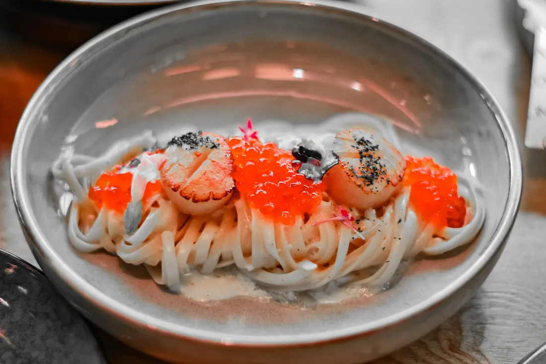 Noodles topped with orange roe