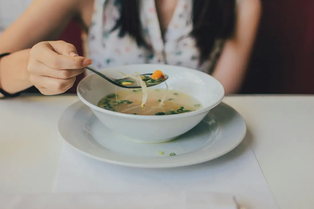A bowl of soup at the table