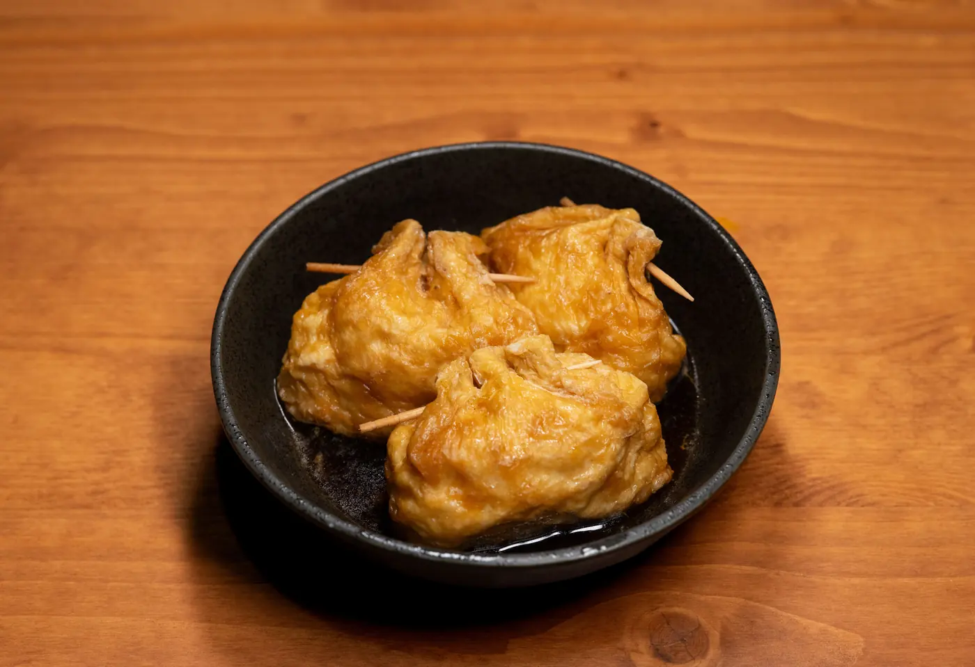 Fried tofu parcels in a bowl