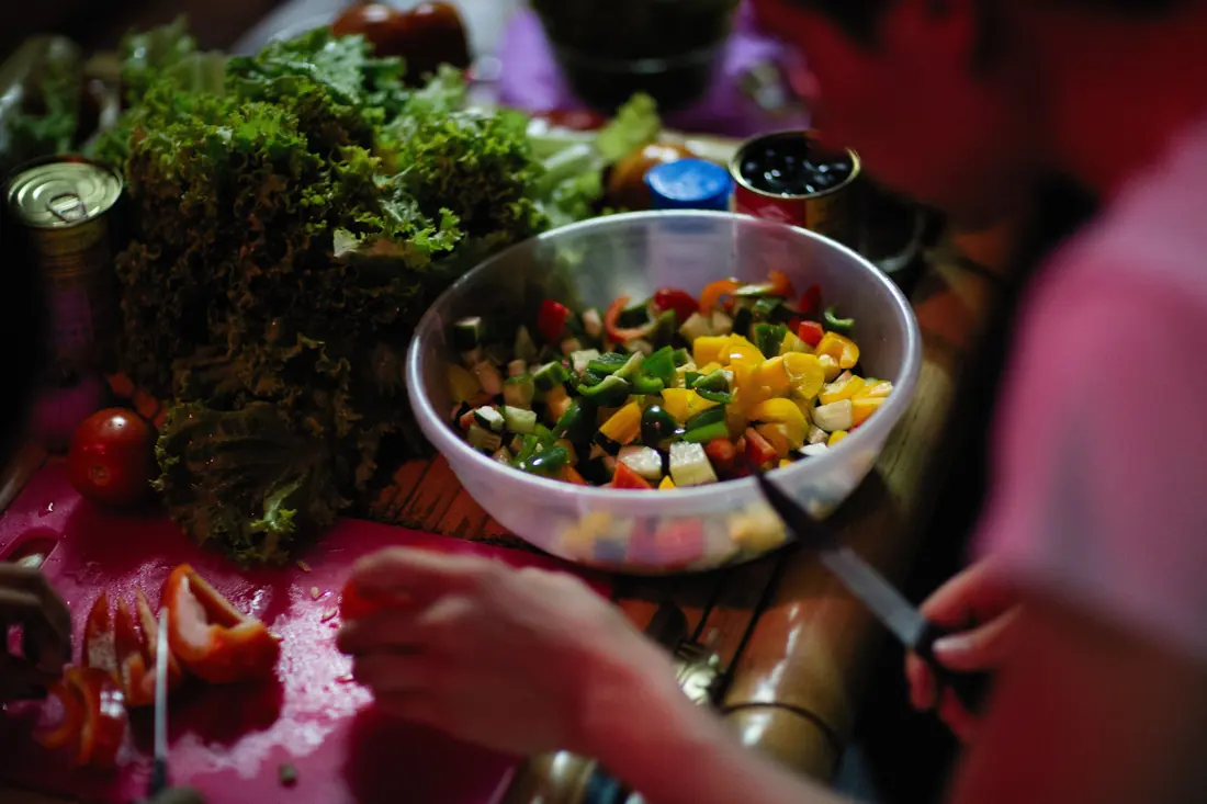 A bowl of chopped vegetables during prep