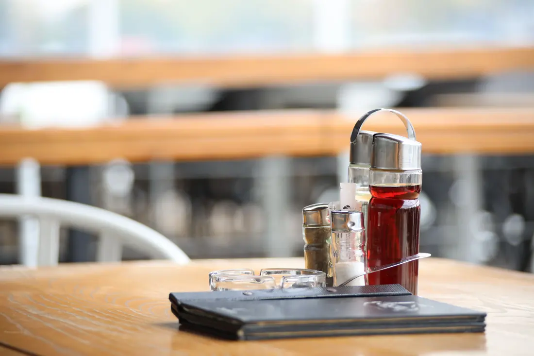 A condiment caddy on a restaurant table