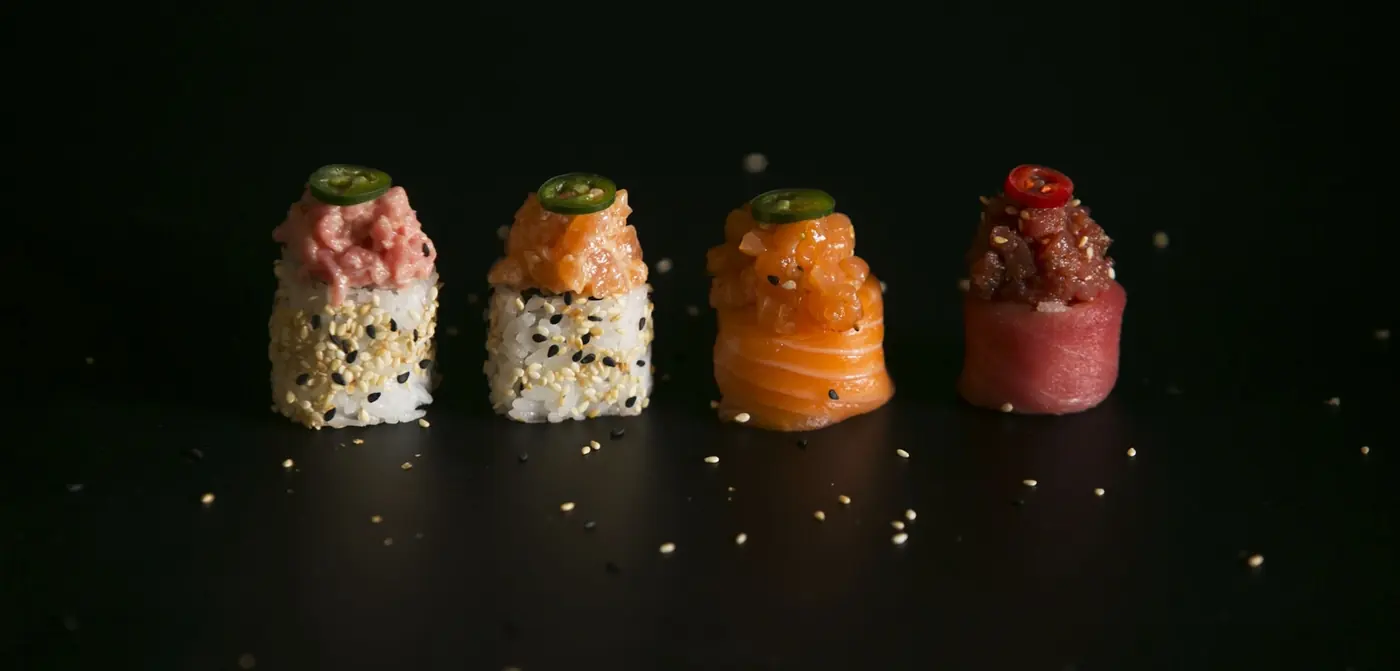 Cooked and raw sushi rolls presented side by side