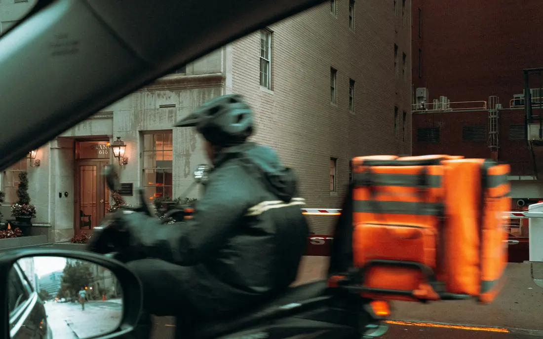 A courier carrying an insulated delivery bag