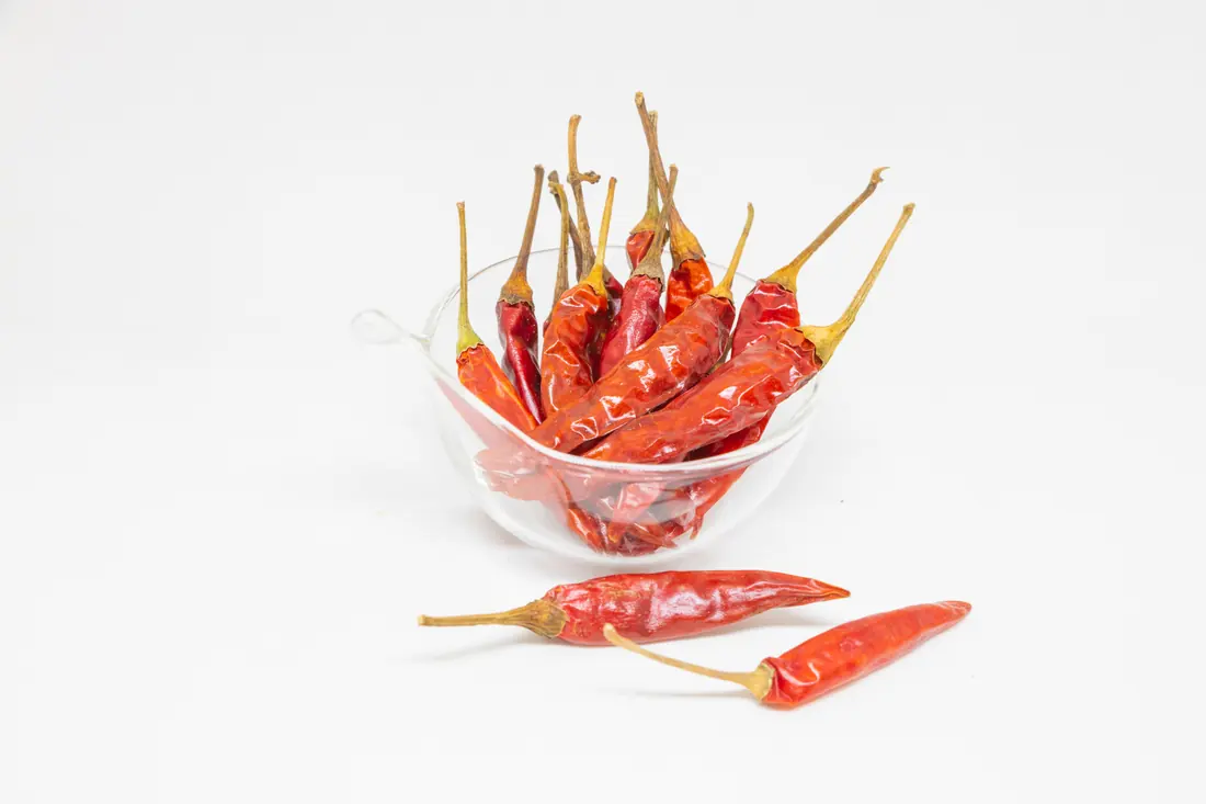 Dried red chillies in a glass bowl