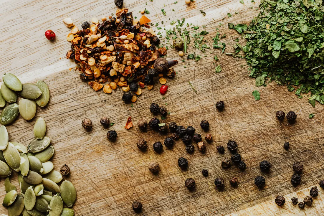 Seeds, spices and herbs on a board