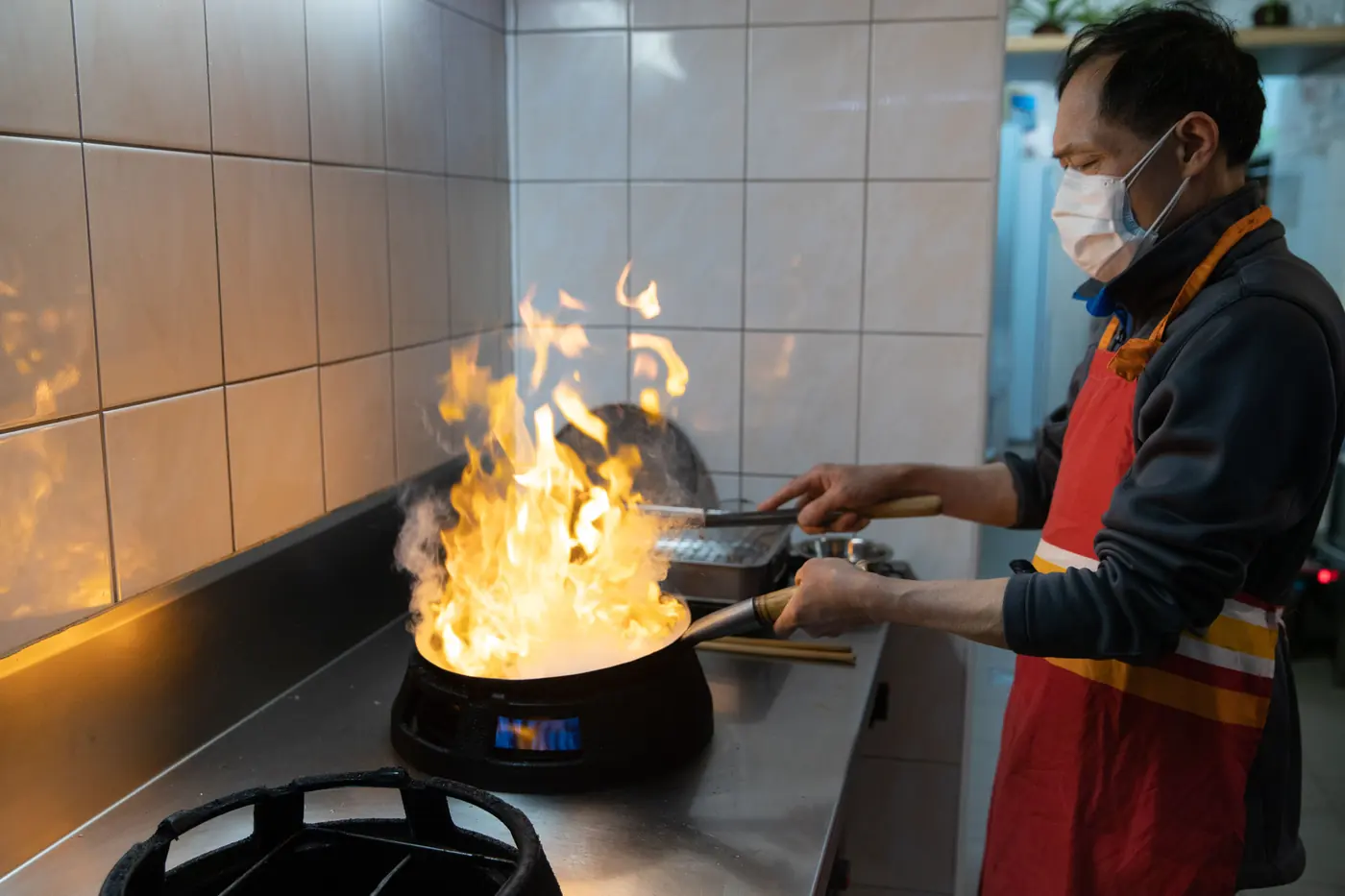 Flames rising from a pan on a high-output burner