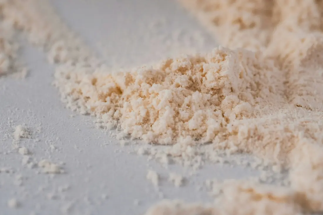 Coarse pale breadcrumbs scattered on a surface