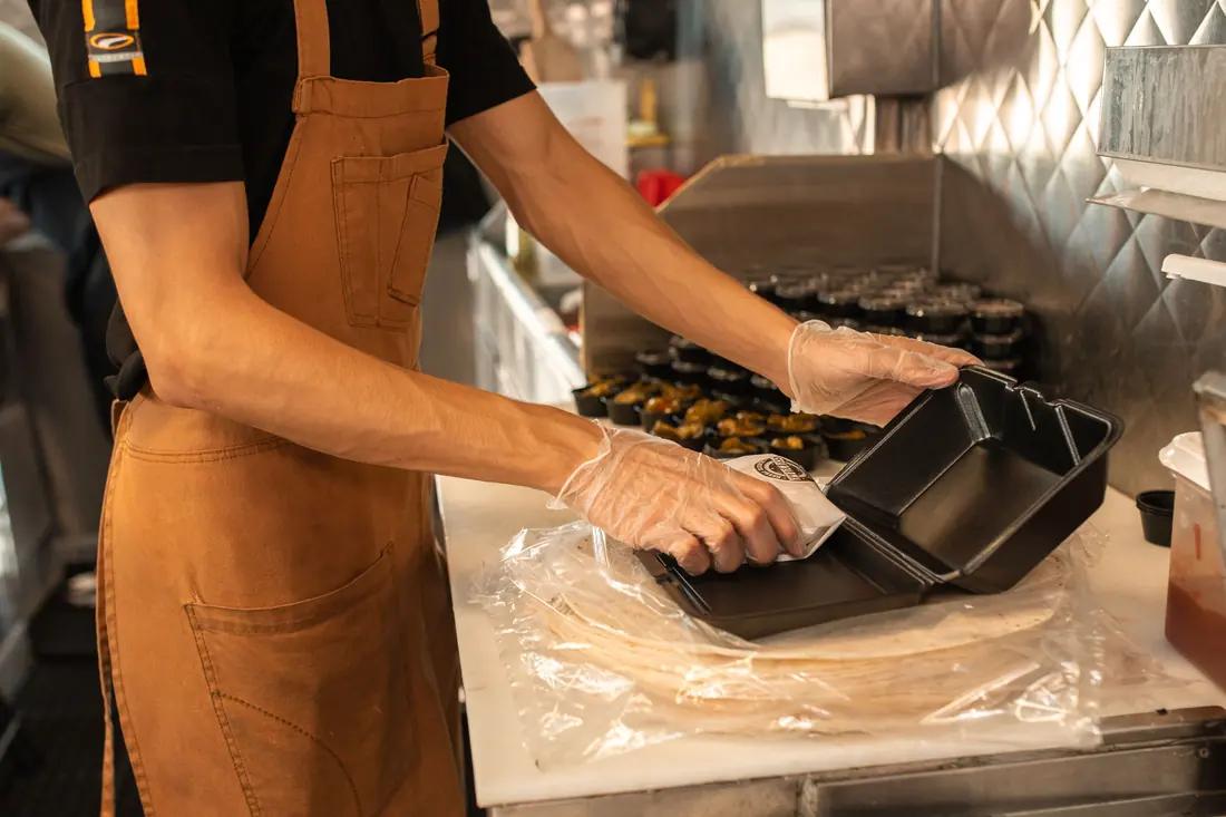 Containers being packed in a kitchen
