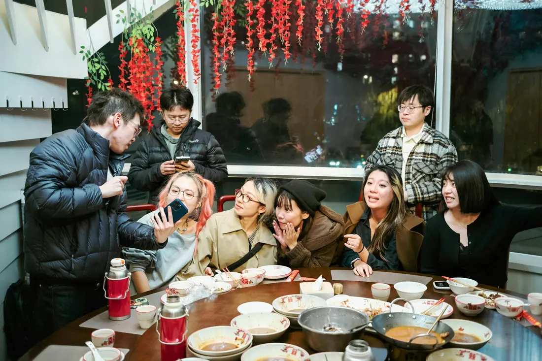 A group sharing dishes around a restaurant table