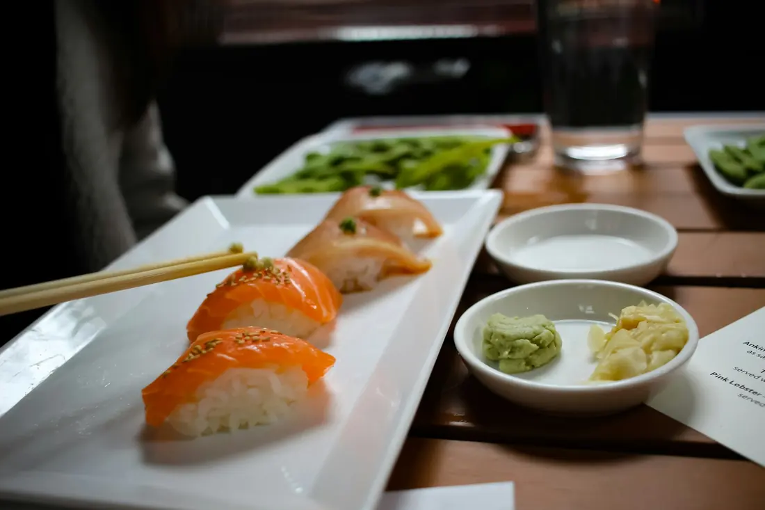 A small mound of green paste served beside sushi