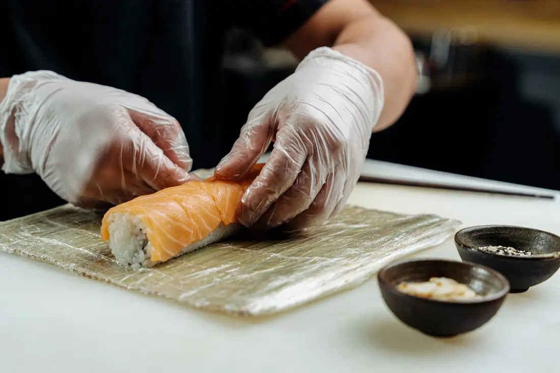 Hands pressing a roll inside a mat