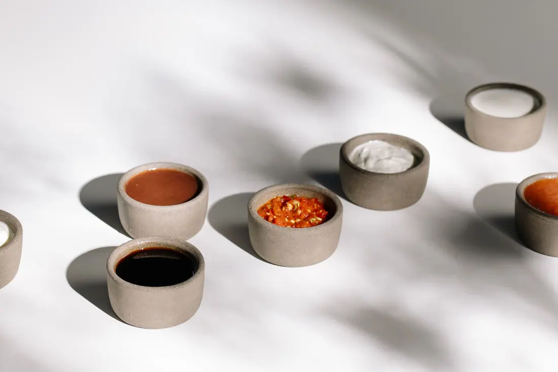 Hoisin and chilli sauce served alongside a noodle soup