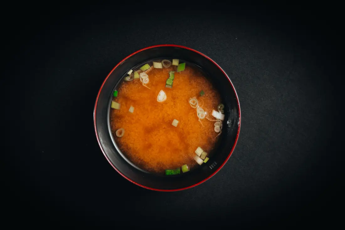 A bowl of miso soup with scallion