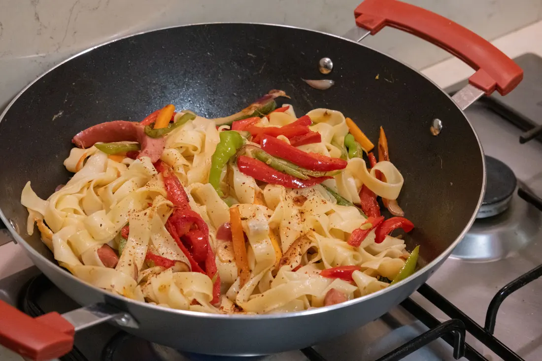 Noodles being stir fried