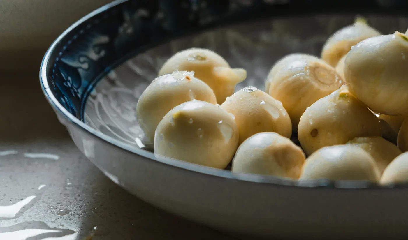 Peeled pale bulbs in a dish