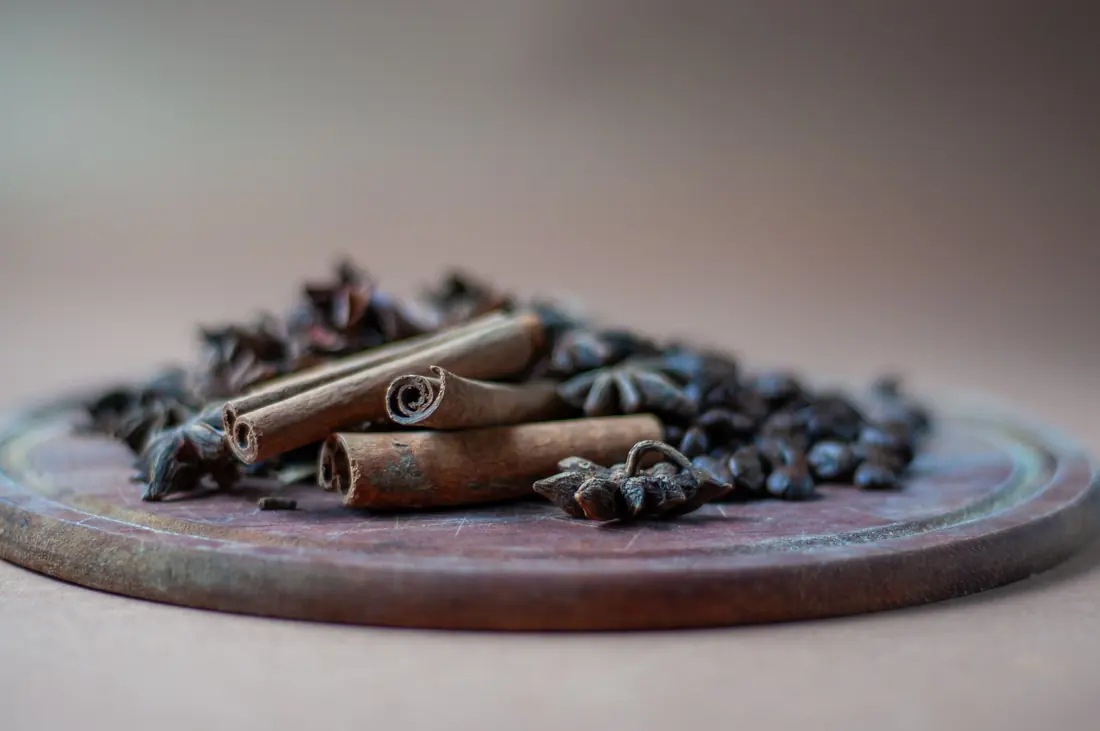 Star anise and cinnamon simmering in a pot of broth