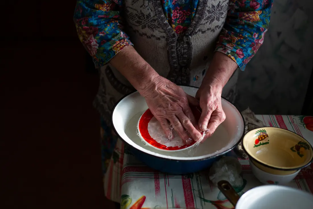 Rice being rinsed in a bowl of water