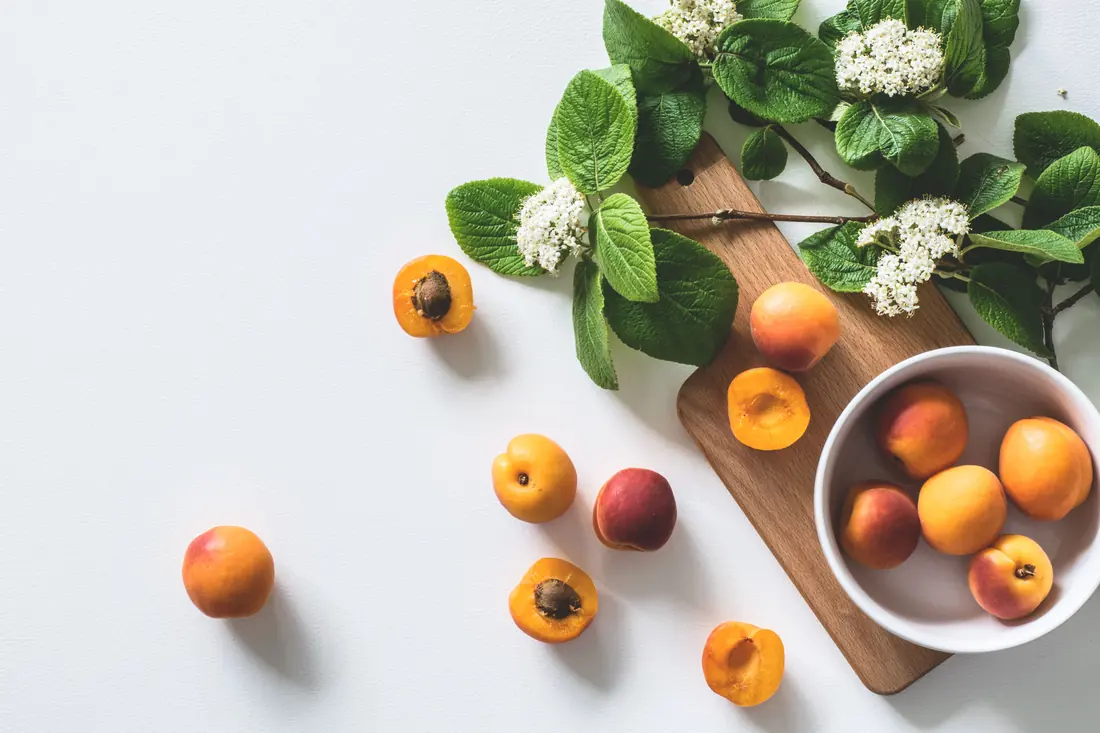 Ripe apricots on a board