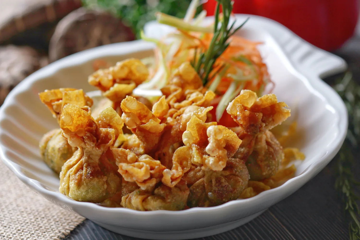 Crispy fried wontons served in a white dish
