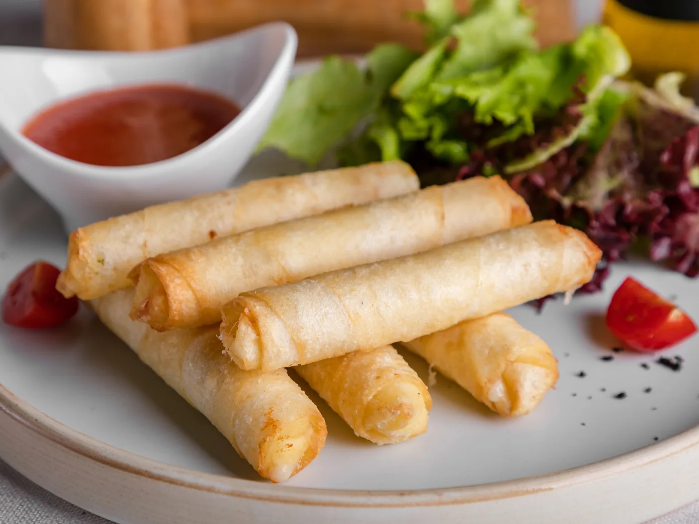 Fried rolls served with a sweet chilli dipping sauce and salad