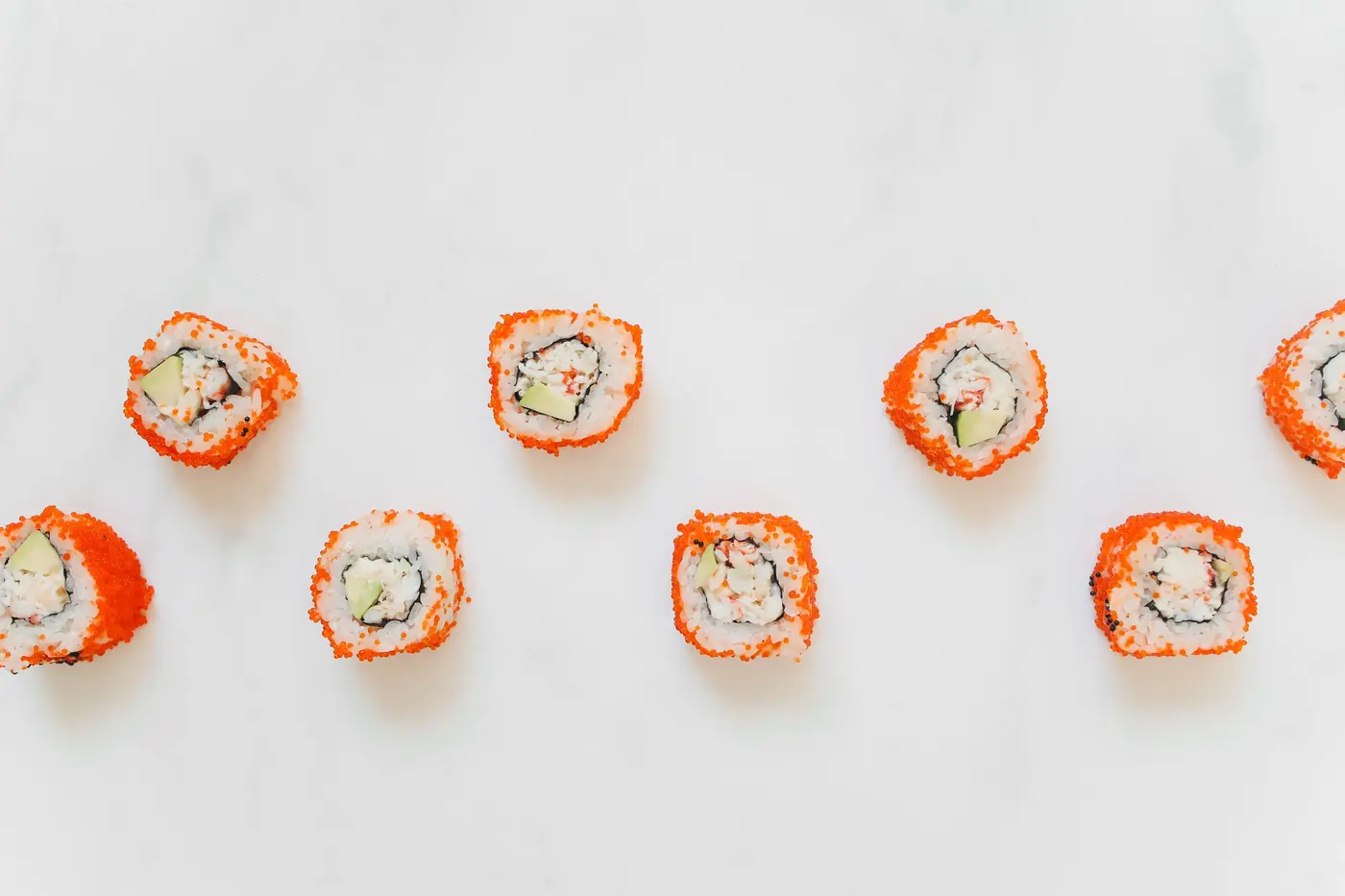 Roll pieces topped with small orange roe