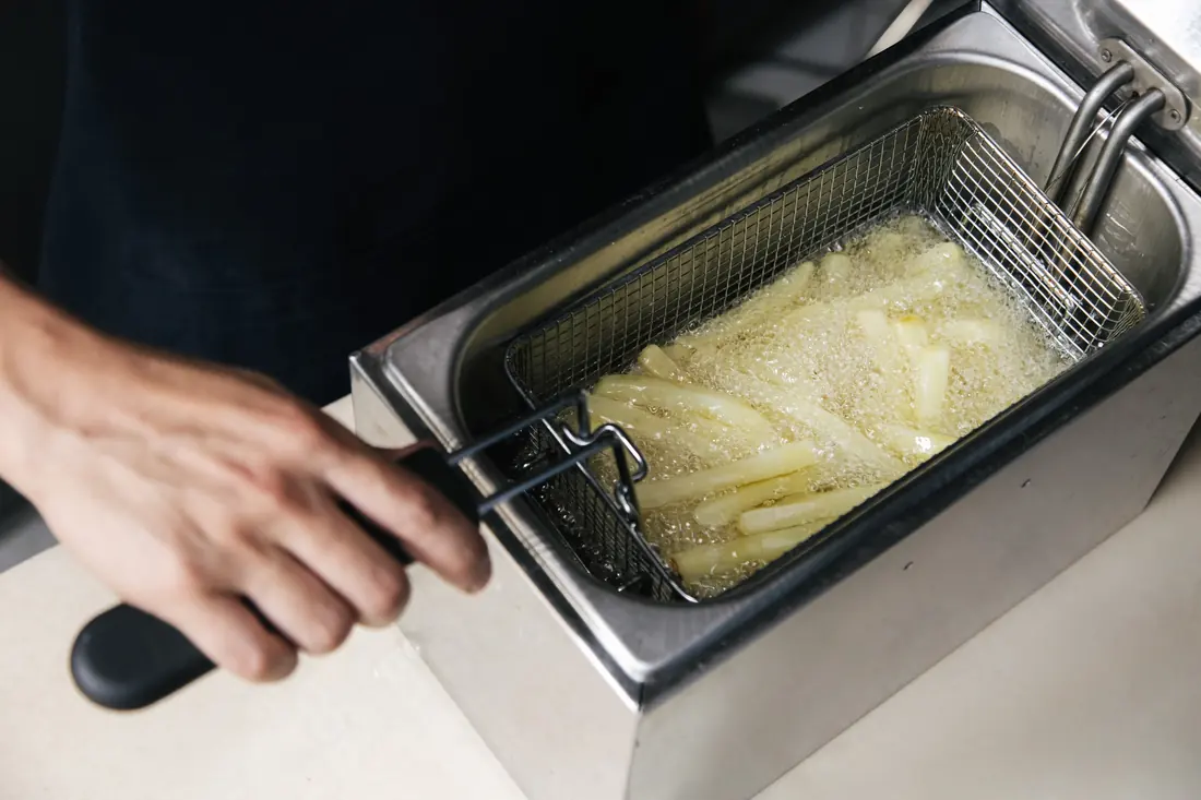 Pale slices in a deep fryer