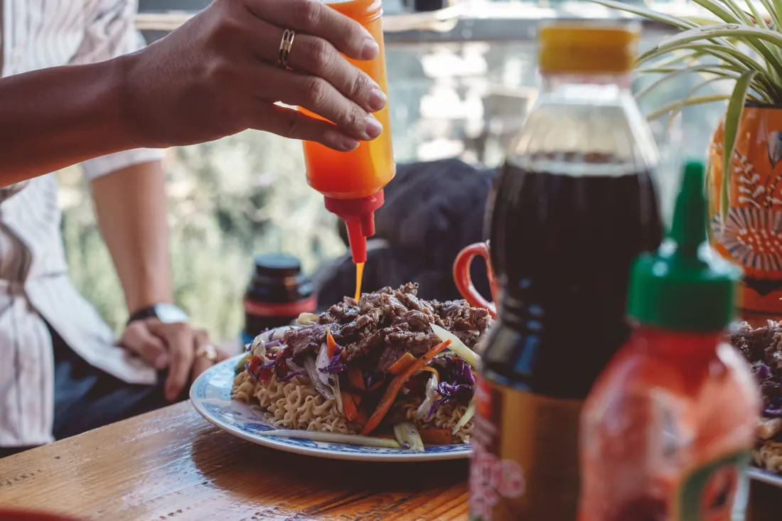 Sauce being squeezed onto a plate