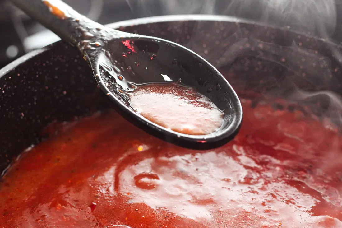 A sauce simmering in a pan