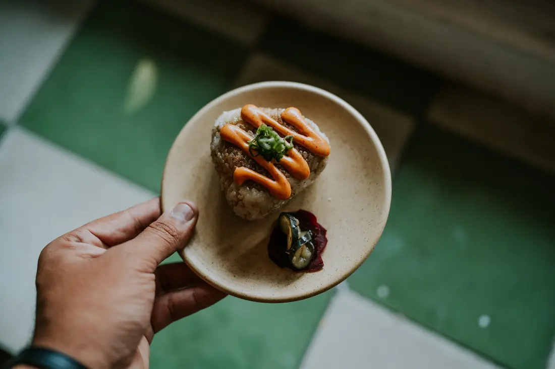 A rice ball on a small plate