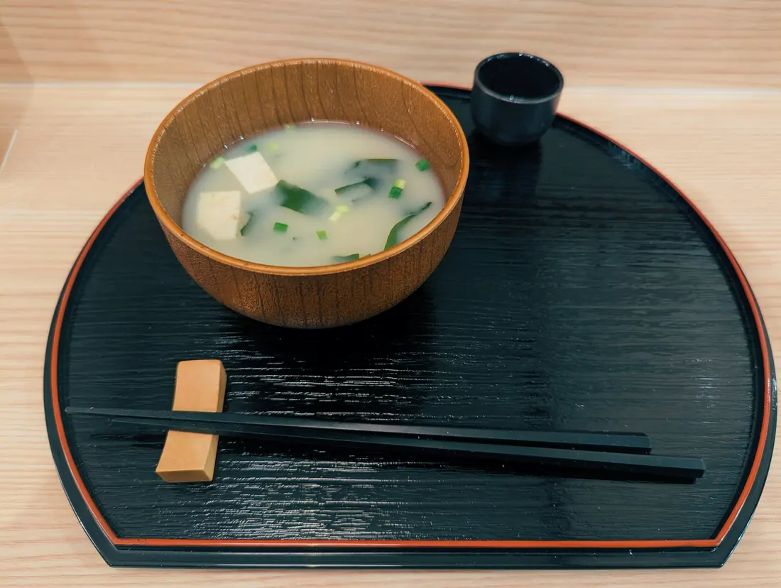 Soft tofu cubes floating in a clear broth