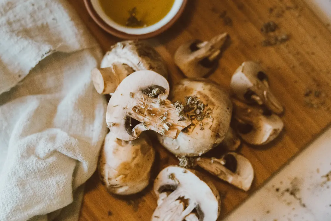 Sliced white mushrooms on a board