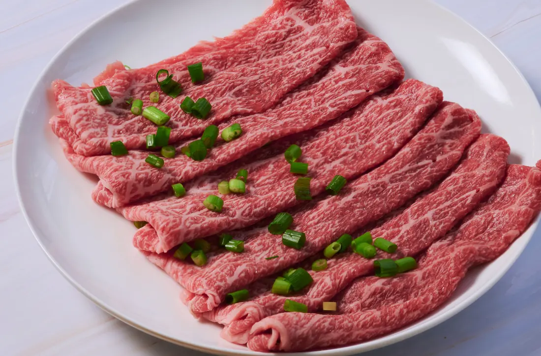 Thinly sliced raw beef with spring onion