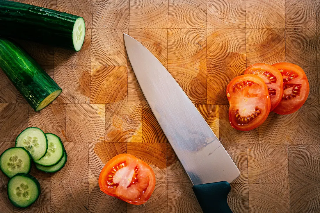 Sliced cucumber and tomato on a board
